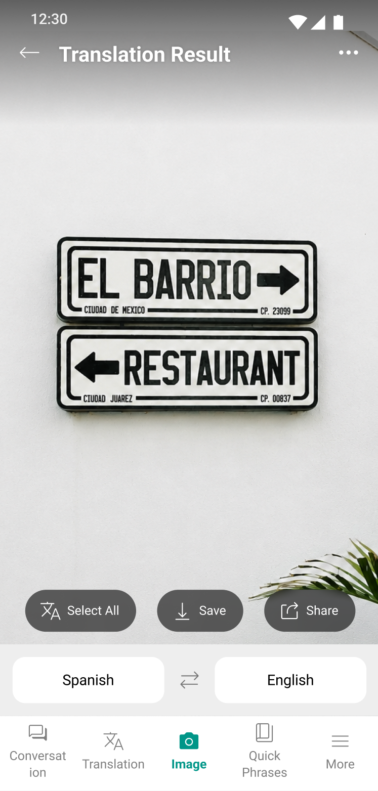 Talking Translator image translation result — a photo of a Spanish sign with the translated words overlaid, plus select-all, save, and share buttons.
